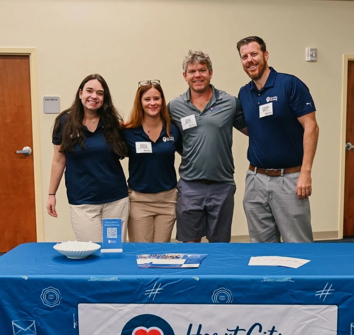 Four Heart City Marketing team members together at a business event